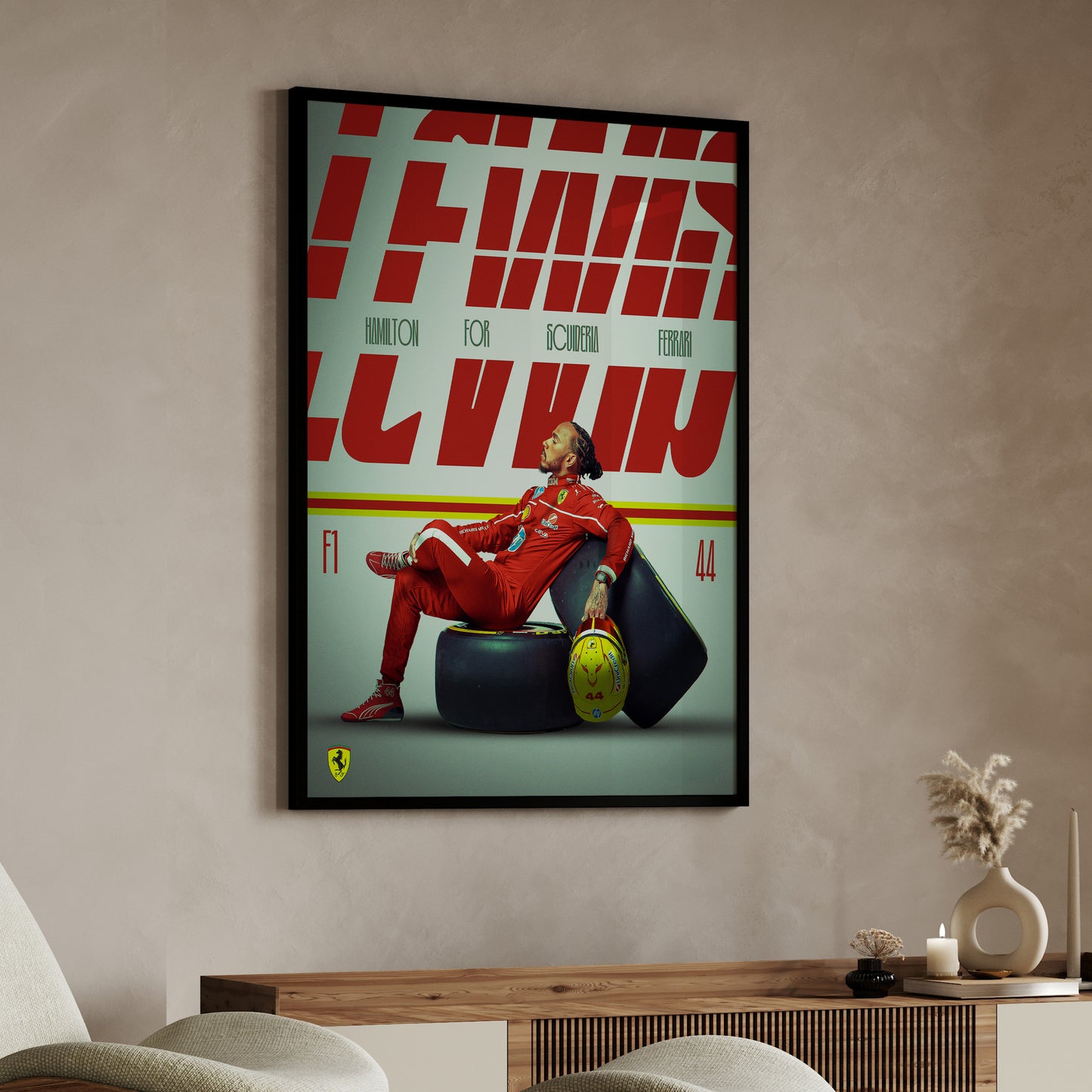 Framed poster of a person in red sitting on a tire with 'Ferrari' branding in a room.
