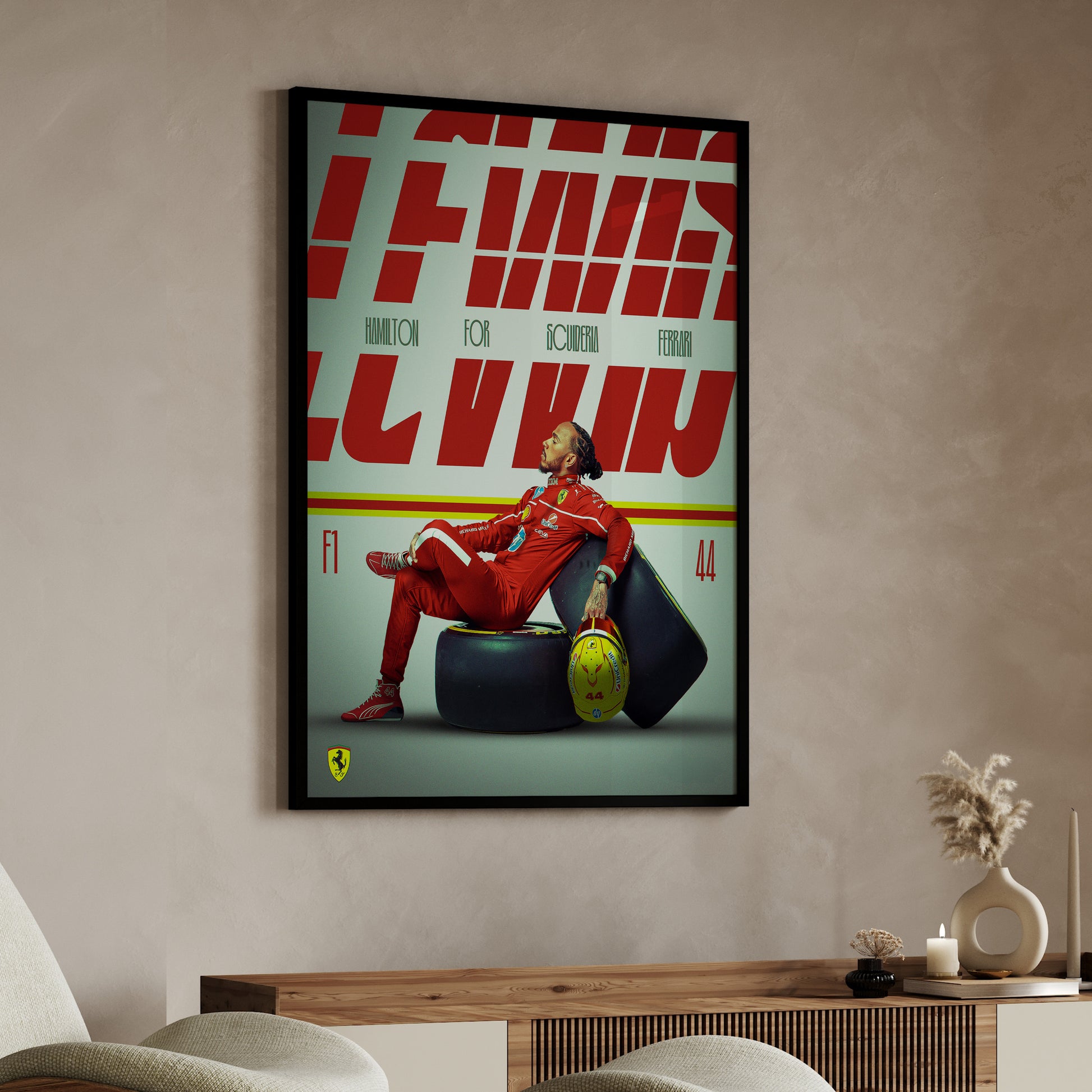 Framed poster of a person in red sitting on a tire with 'Ferrari' branding in a room.